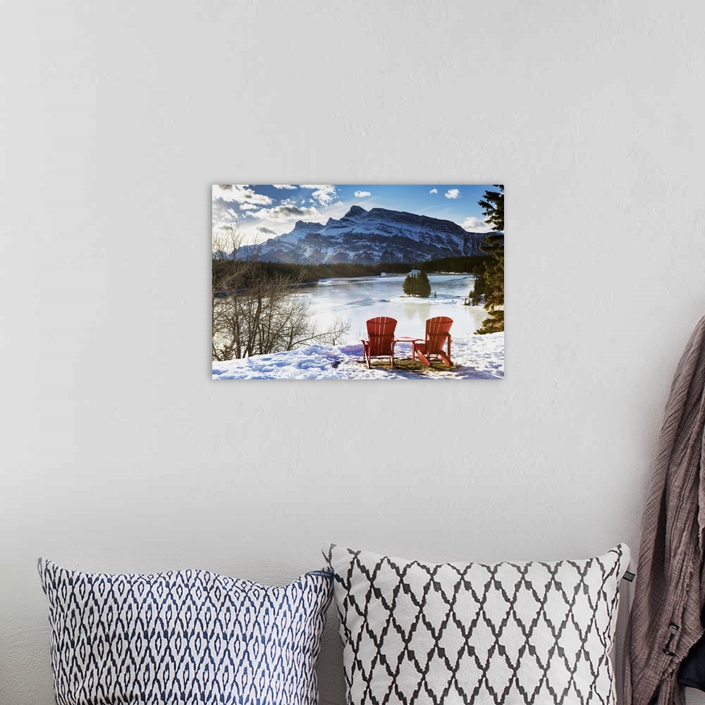 A bohemian room featuring Two Red Chairs On Snow Covered Ridge Overlooking Frozen Lake, Banff, Alberta, Canada