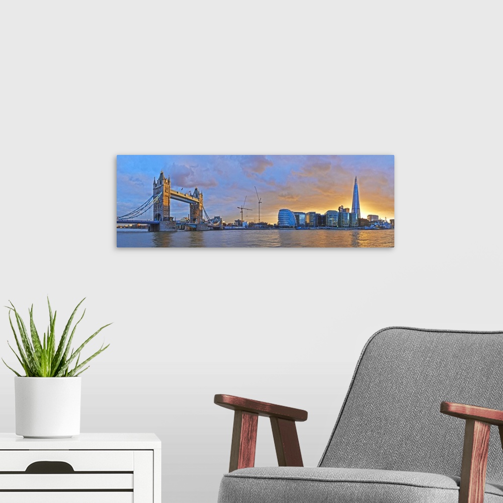 A modern room featuring UK, City Hall and Tower Bridge at sunset from River Thames, London