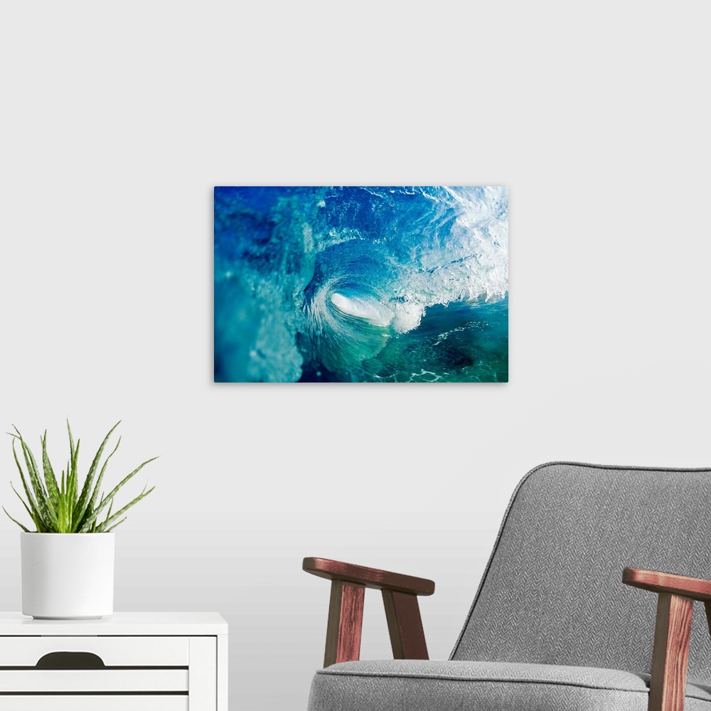 A modern room featuring Big photo on canvas of a wave rolling and about to crash in the ocean.