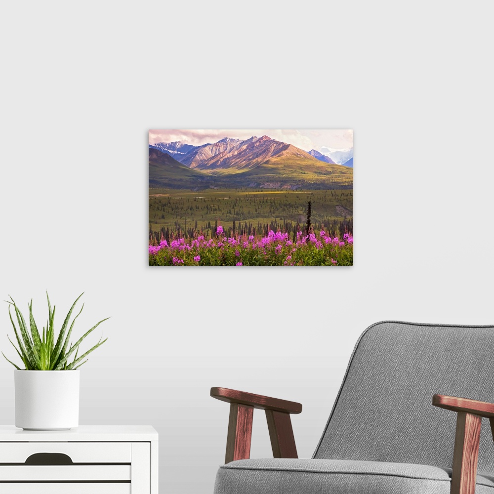 A modern room featuring This is a landscape photograph of the view across a valley to the mountains on the far side.