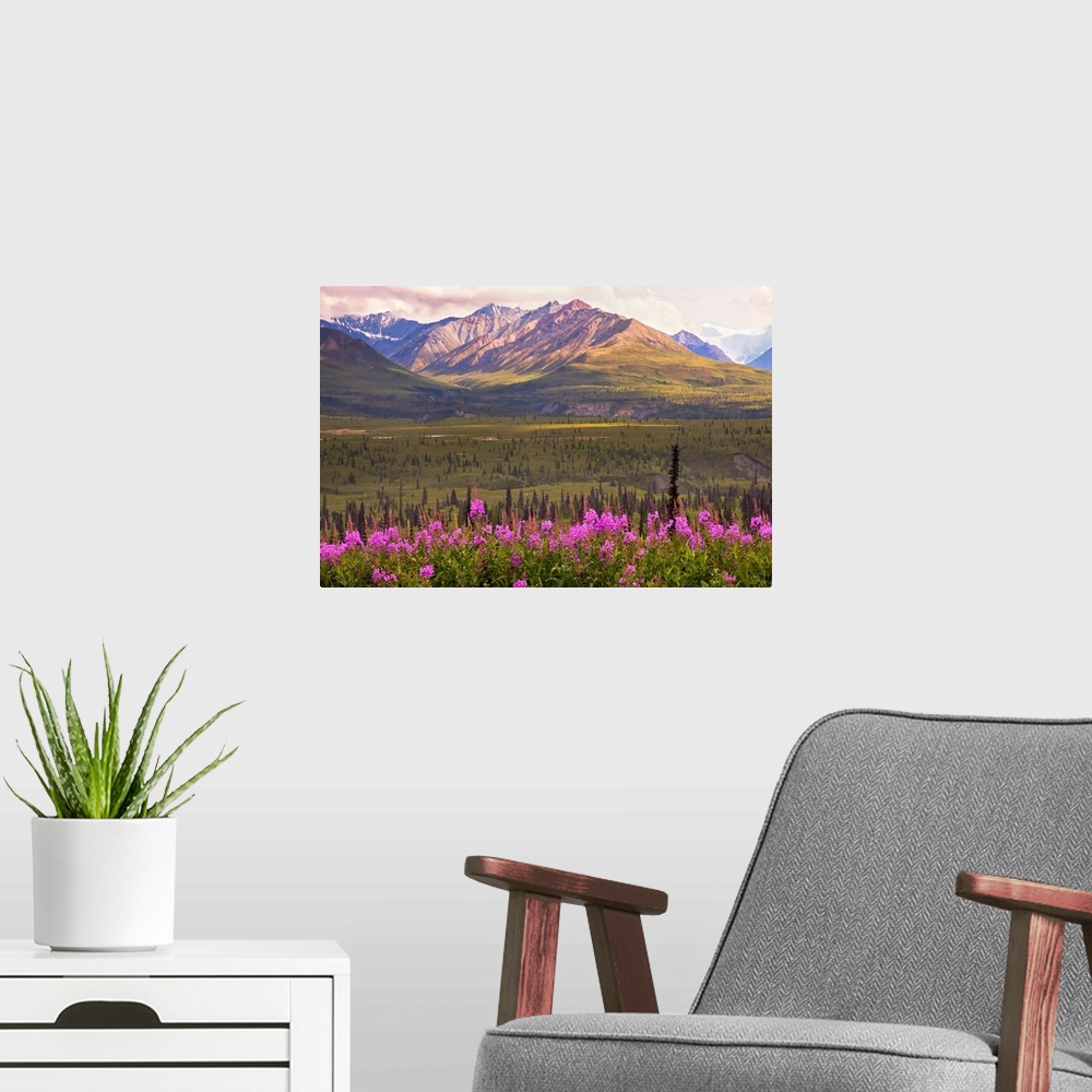 A modern room featuring This is a landscape photograph of the view across a valley to the mountains on the far side.