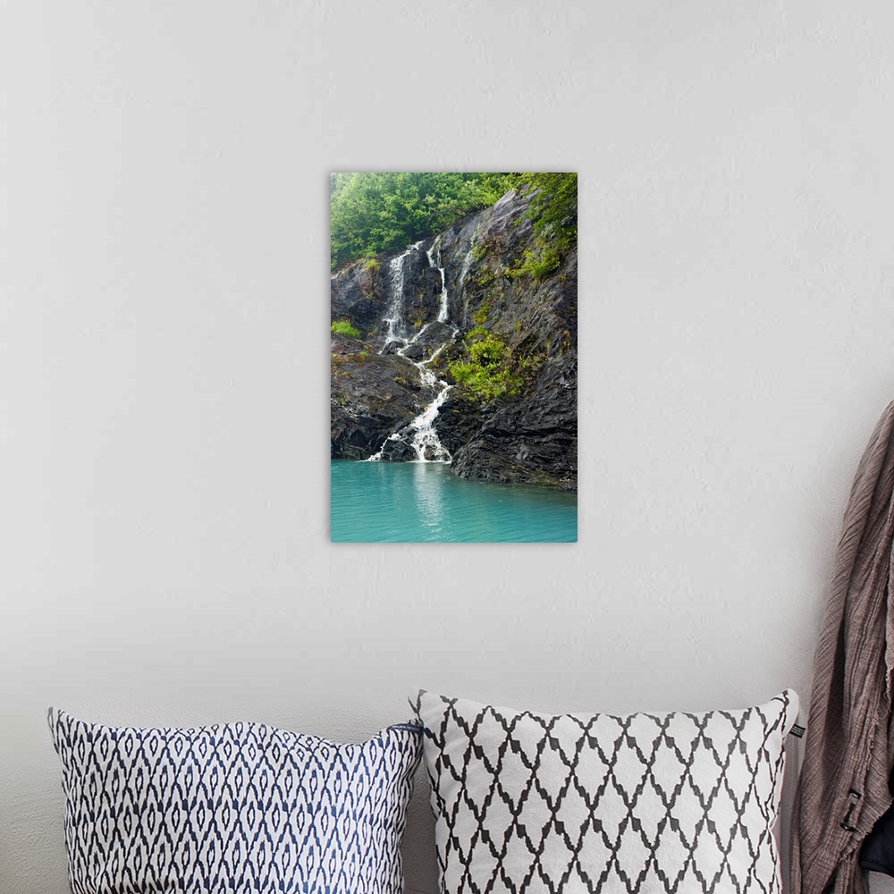 A bohemian room featuring Waterfall cascading down the rocks of the Passage Canal in Whittier, Alaska.