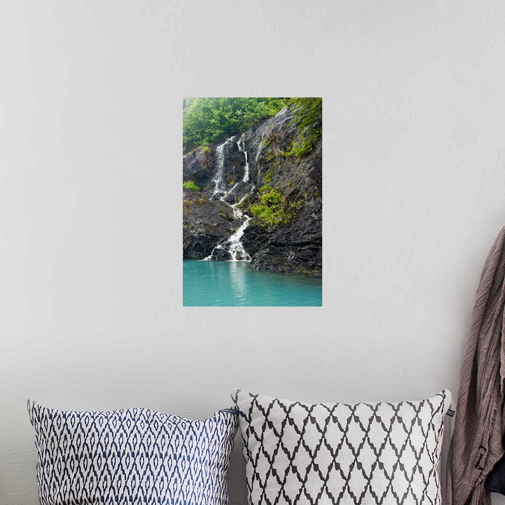 A bohemian room featuring Waterfall cascading down the rocks of the Passage Canal in Whittier, Alaska.