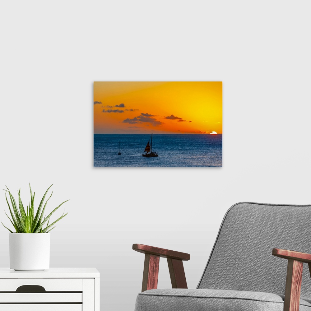 A modern room featuring Sunset over the ocean with sailboats off Waikiki Beach; Honolulu, Oahu, Hawaii, United States of ...