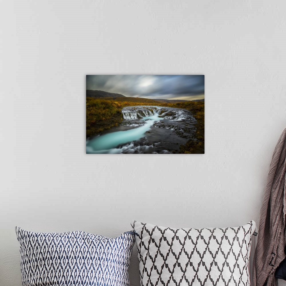 A bohemian room featuring Long Exposure Of Water Flowing Over Rock In A Stream And Dark Clouds In The Sky, Bruarfoss, Iceland