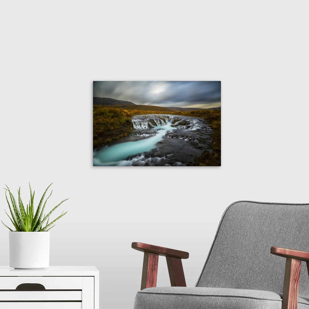 A modern room featuring Long Exposure Of Water Flowing Over Rock In A Stream And Dark Clouds In The Sky, Bruarfoss, Iceland