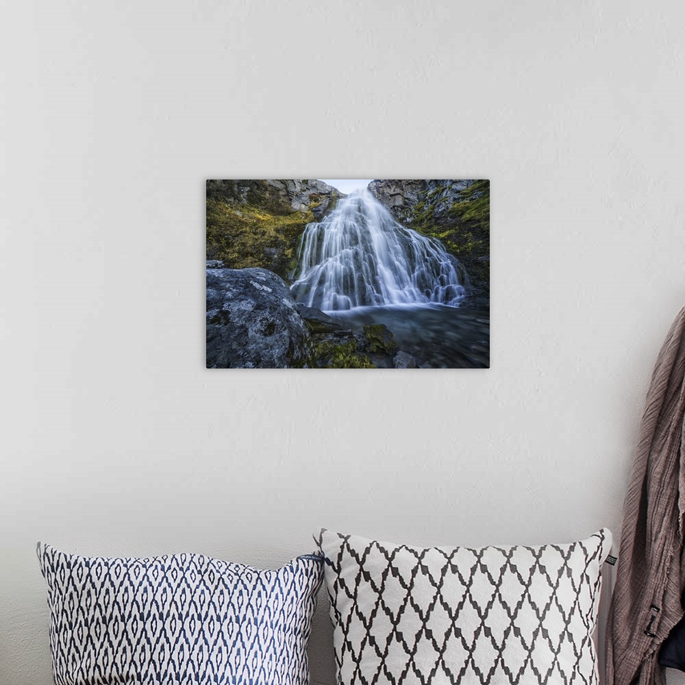 A bohemian room featuring Waterfall along the road, west fjords, Iceland.