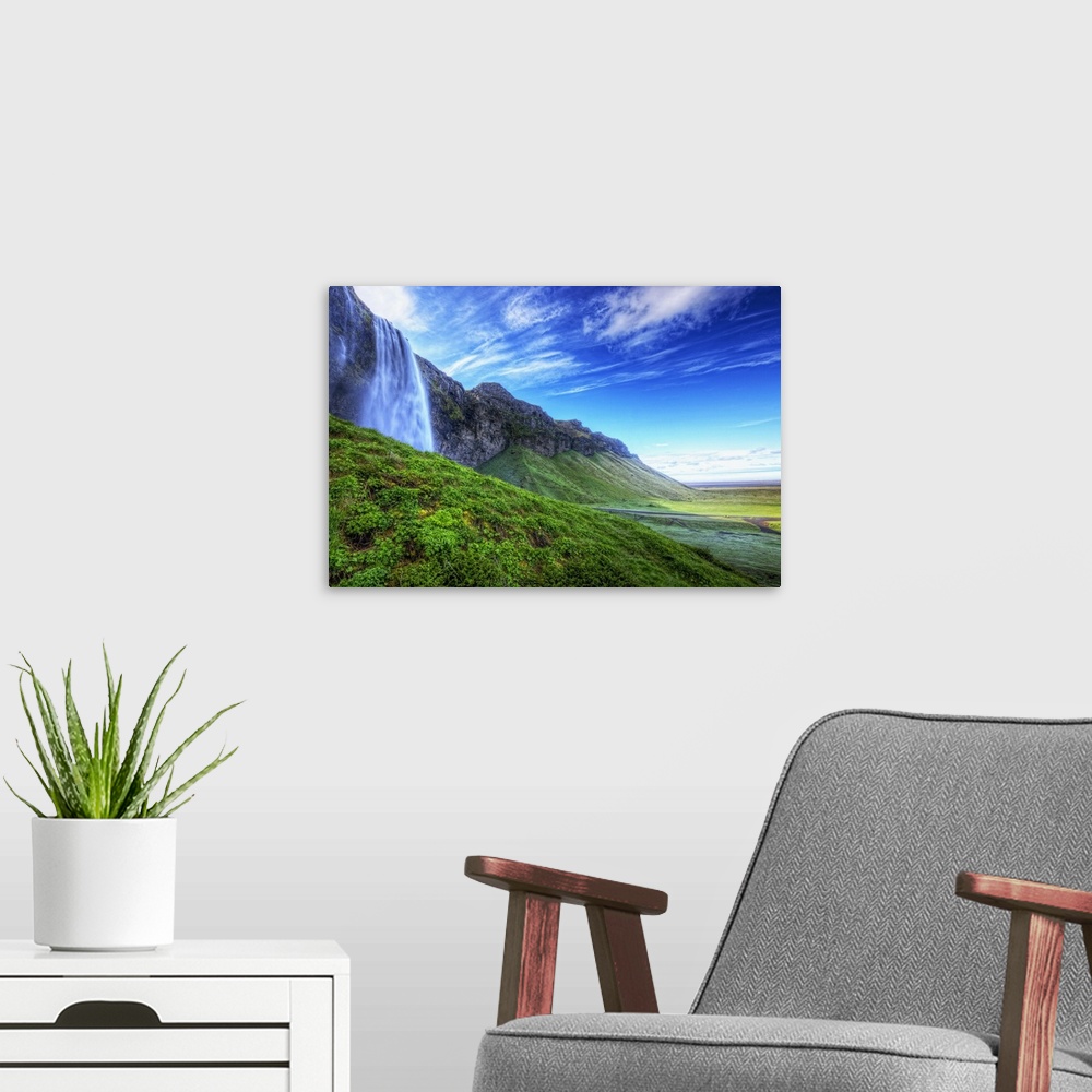 A modern room featuring HDR of waterfall Seljalandsfoss along the southern coast of Iceland; Iceland