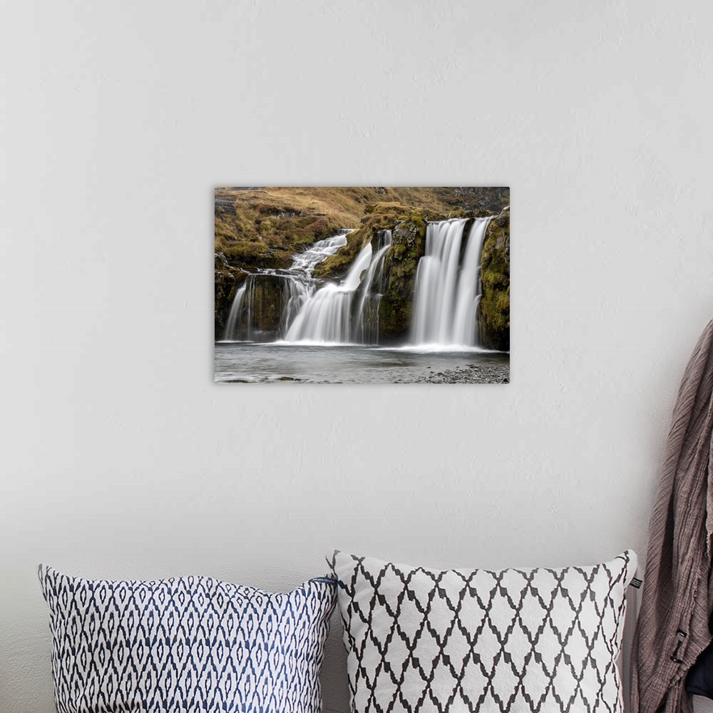 A bohemian room featuring Waterfalls cascading over the cliffs in the rugged countryside Iceland