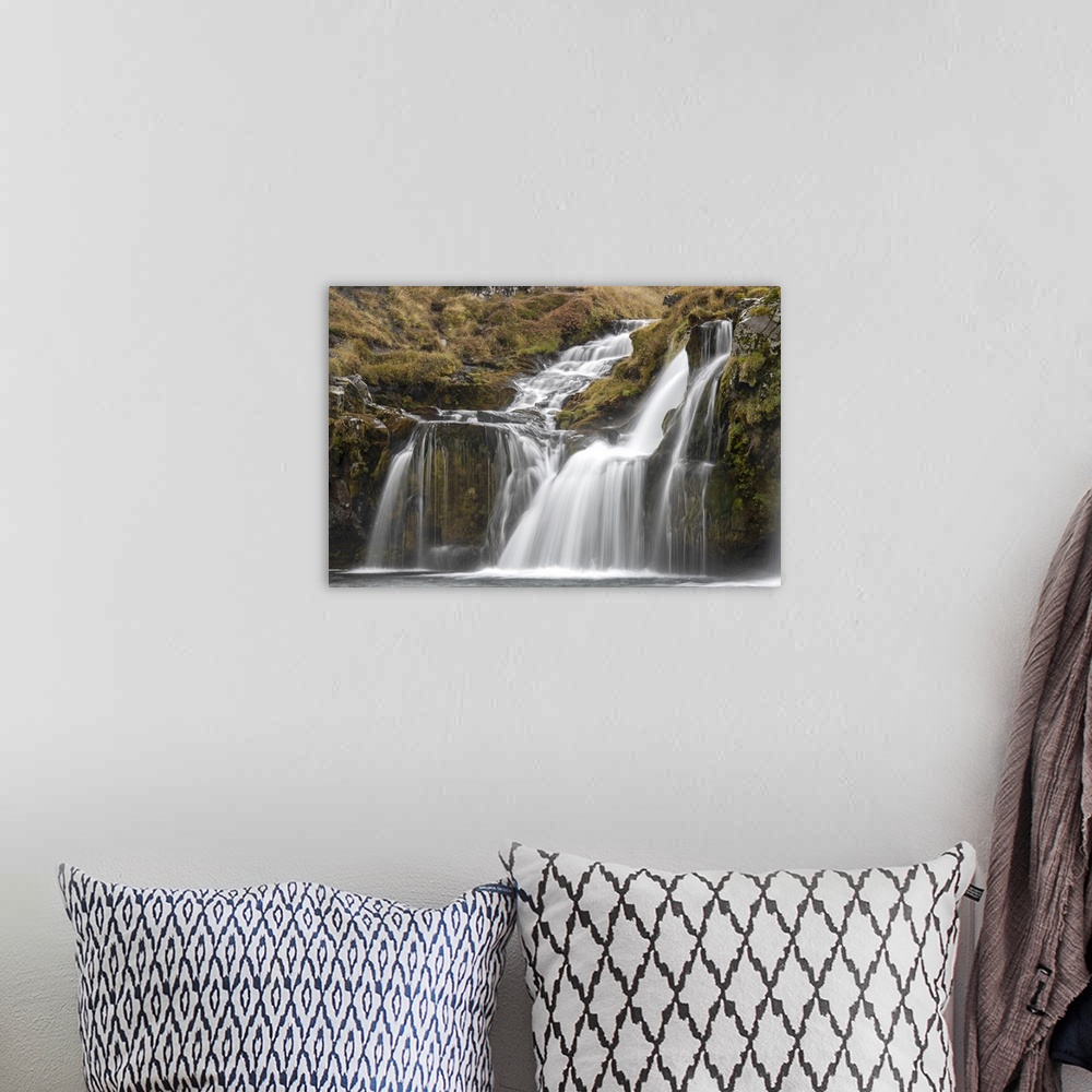 A bohemian room featuring Waterfalls cascading over the cliffs in the rugged countryside Iceland