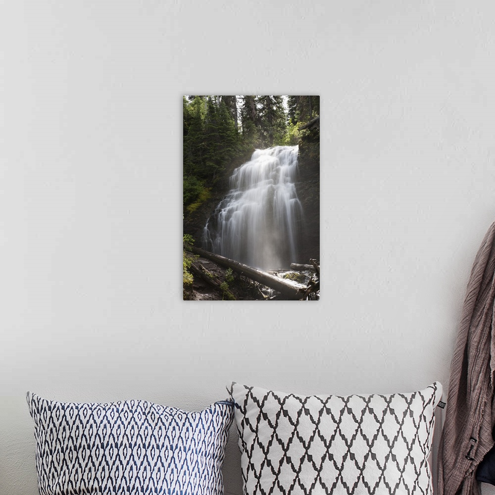 A bohemian room featuring Waterfalls Flowing Down A Rock Cliff; Waterton, Alberta, Canada
