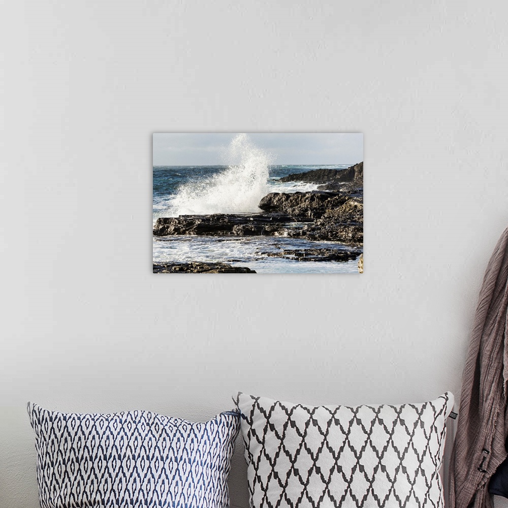 A bohemian room featuring Wave crashing into rocky coast with cloudy sky, Kilkee, County Clare, Ireland