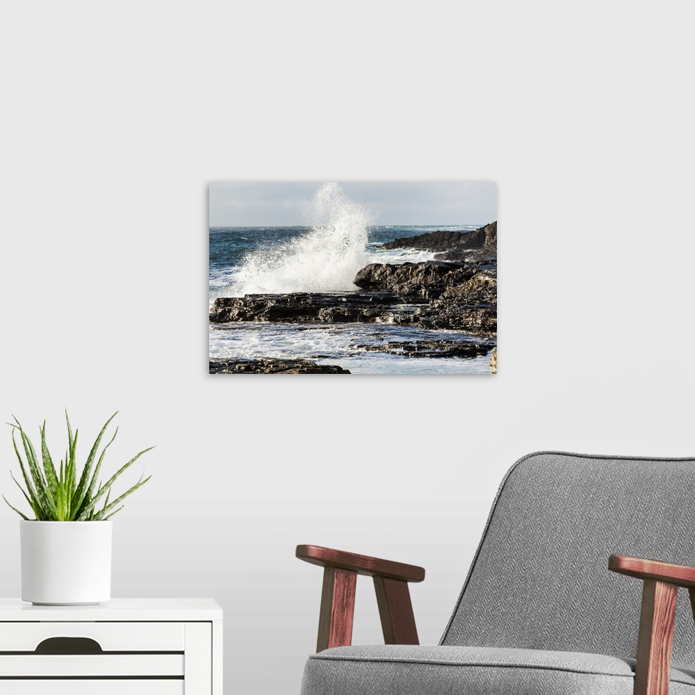 A modern room featuring Wave crashing into rocky coast with cloudy sky, Kilkee, County Clare, Ireland