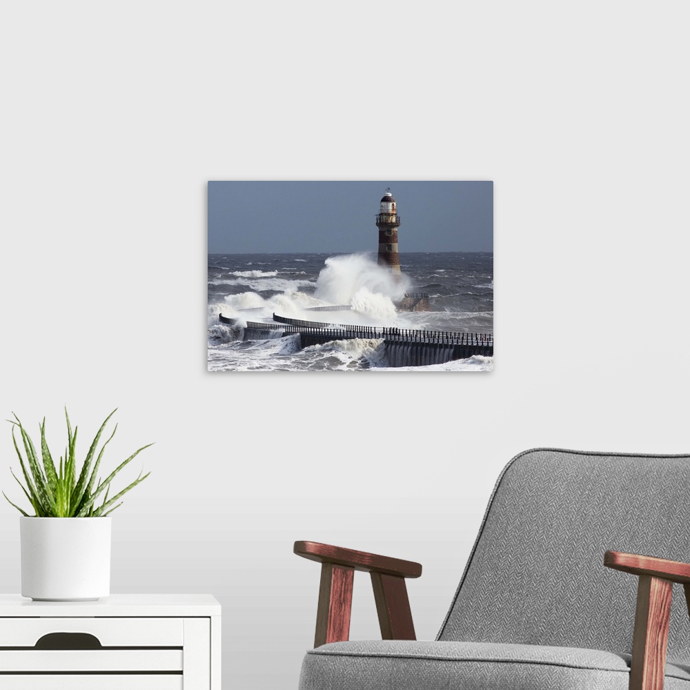 A modern room featuring Waves crashing into a lighthouse on the coast, Sunderland Tyne and Wear England