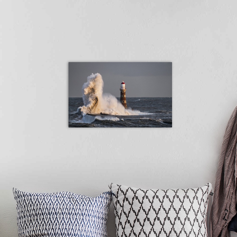 A bohemian room featuring Waves Splashing Against Roker Lighthouse At The End Of A Pier; Sunderland, Tyne And Wear, England