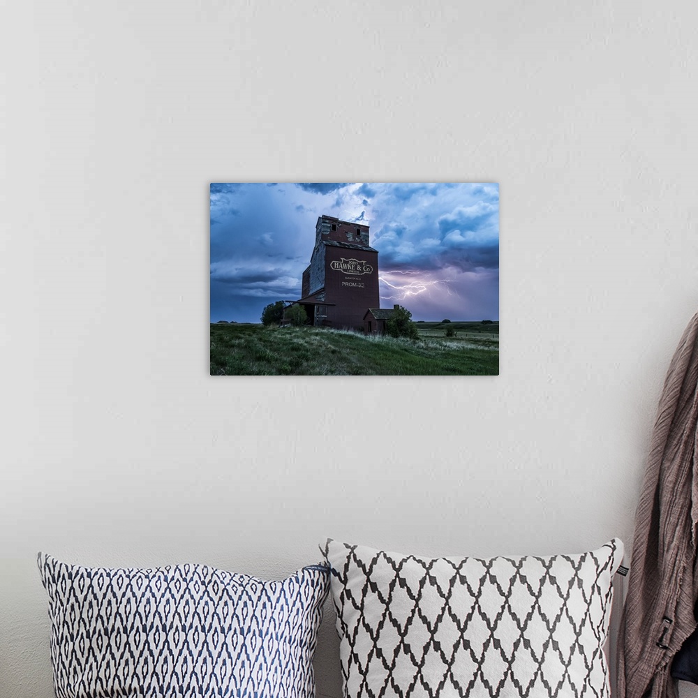 A bohemian room featuring Weathered grain elevator and electrical storm on the prairies; Saskatchewan, Canada