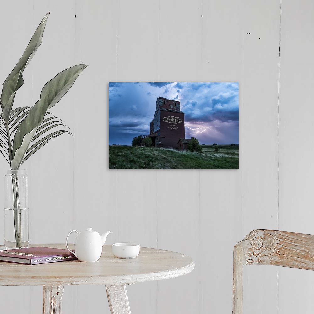 A farmhouse room featuring Weathered grain elevator and electrical storm on the prairies; Saskatchewan, Canada