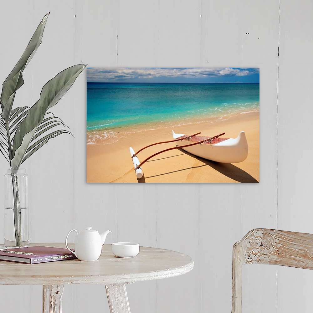A farmhouse room featuring Horizontal canvas of a canoe sitting on a beach with crystal clear water washing ashore from the ...