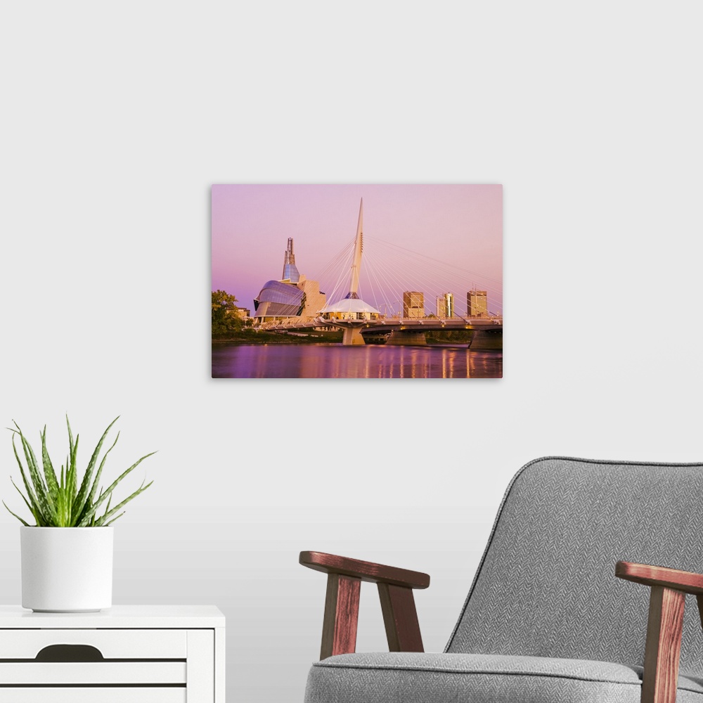 A modern room featuring Winnipeg skyline from St. Boniface showing the Red River, Esplanade Riel Bridge and Canadian Muse...