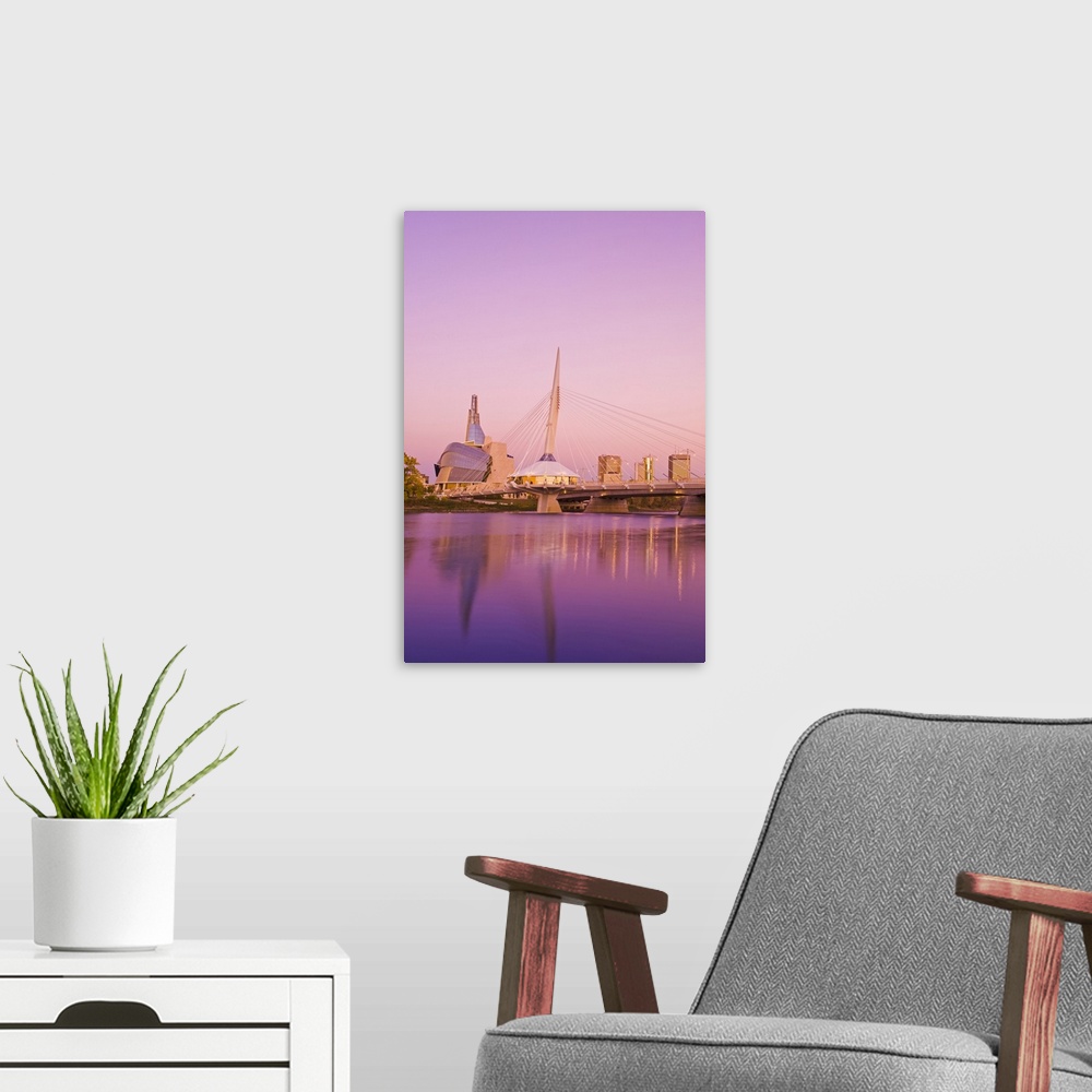 A modern room featuring Winnipeg skyline from St. Boniface showing the Red River, Esplanade Riel Bridge and Canadian Muse...