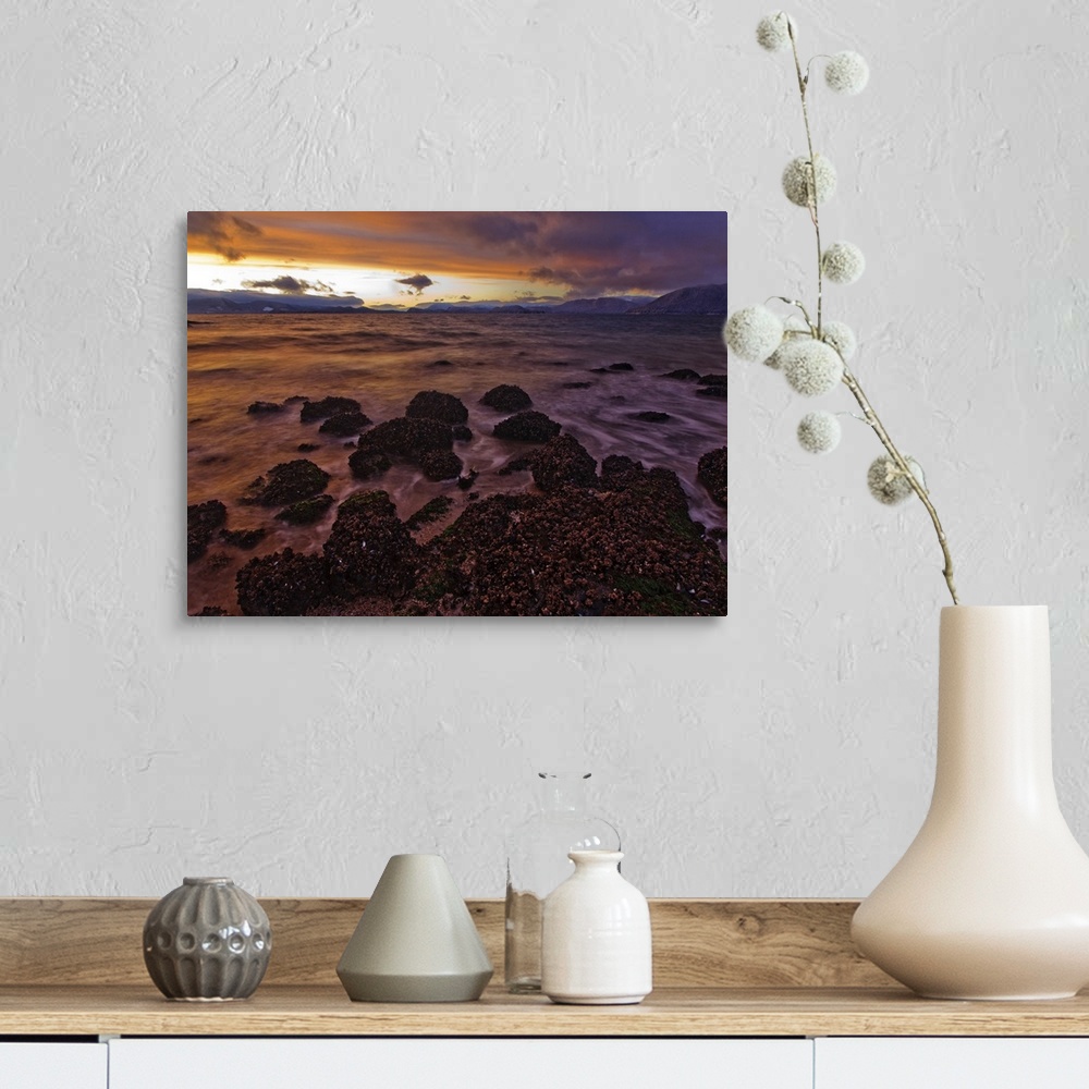A farmhouse room featuring The view North over Zimovia Strait from Petroglyph Beach at sunset as small waves move over the b...