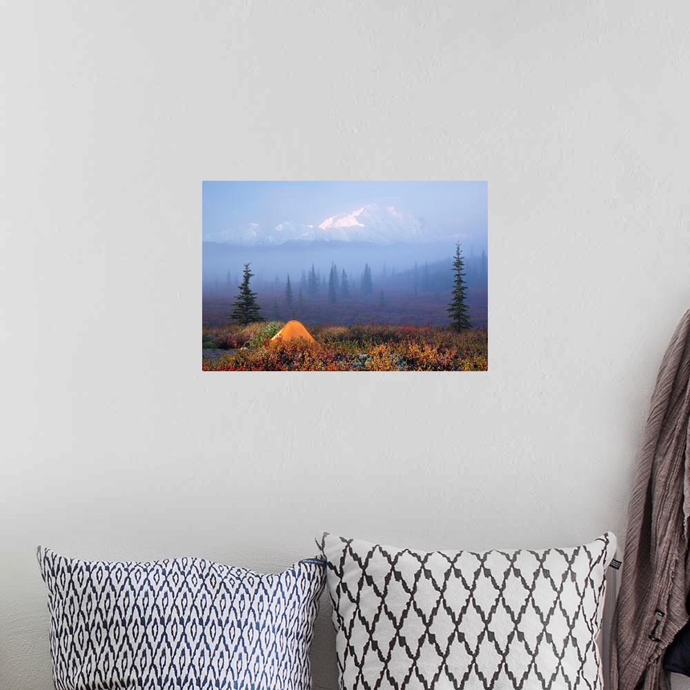 A bohemian room featuring A snow covered mountain range is shown vaguely behind a dense layer of fog that also covers a vas...