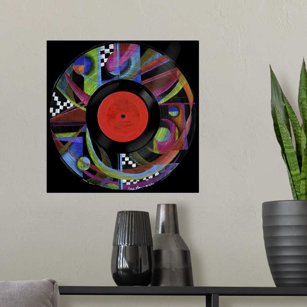 A modern room featuring Square abstract painting of vivid colored shapes in the design of a vinyl record.