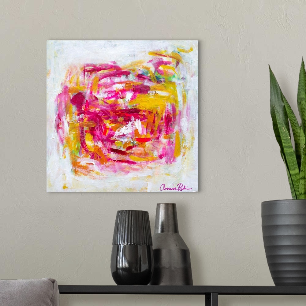 A modern room featuring Abstract contemporary artwork in cheerful pinks and yellows.