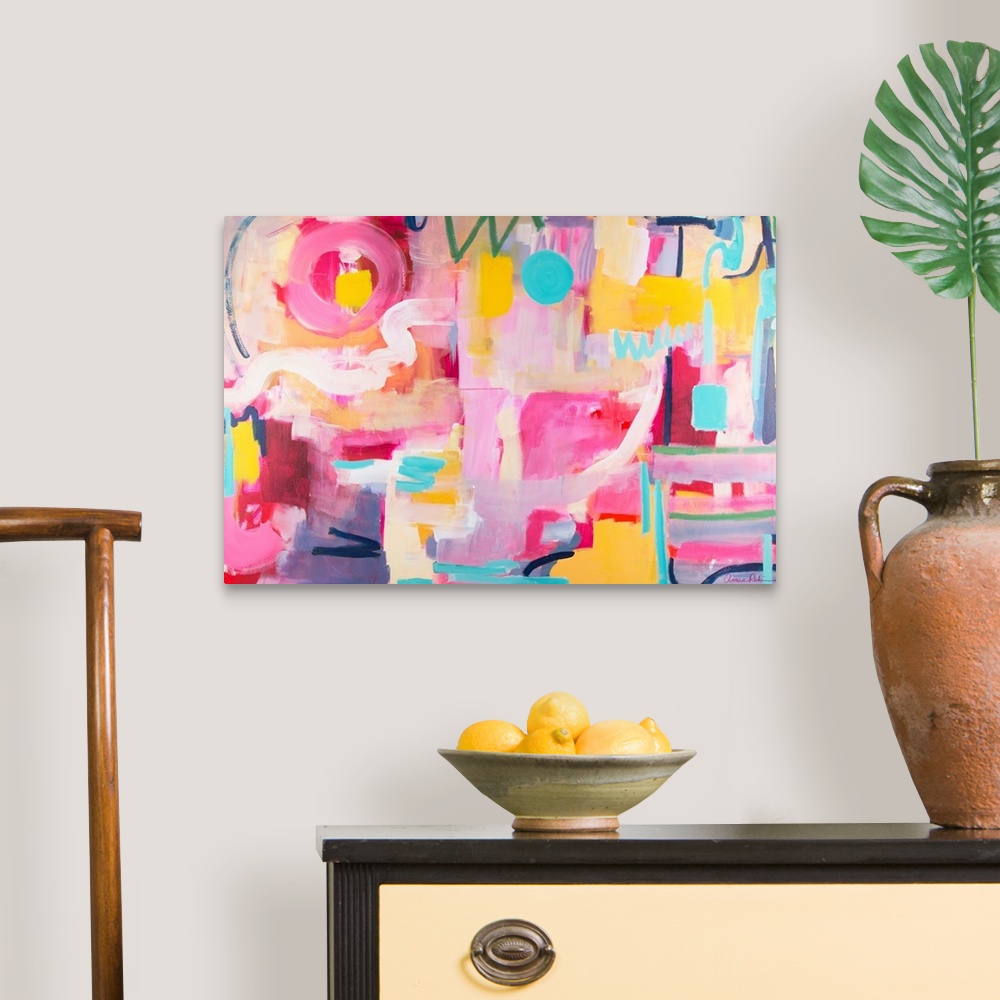 A traditional room featuring Contemporary artwork in pink, yellow, and turquoise.