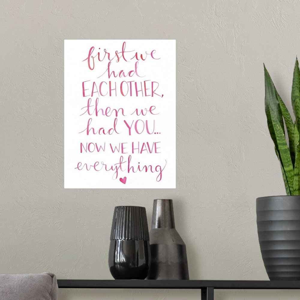 A modern room featuring The words "First we had each other, then we had you... now we have everything." hand written in l...