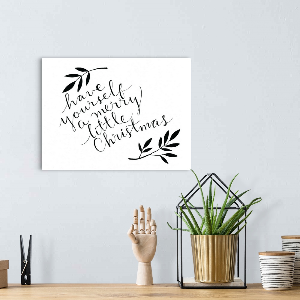 A bohemian room featuring The words "Have yourself a merry little Christmas" handwritten on white surrounded by two leafy b...