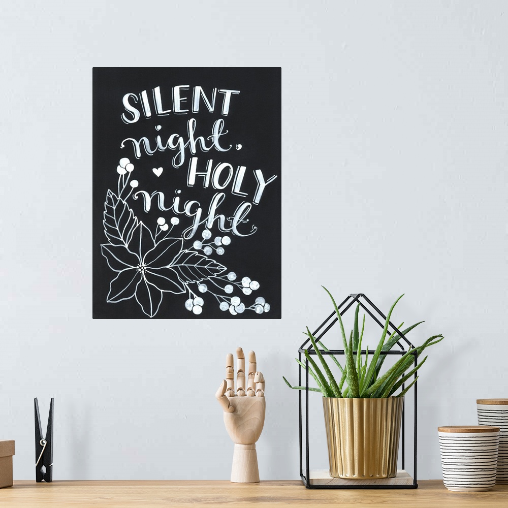 A bohemian room featuring The words "Silent night, holy night" handwritten on a dark background with a large poinsettia flo...
