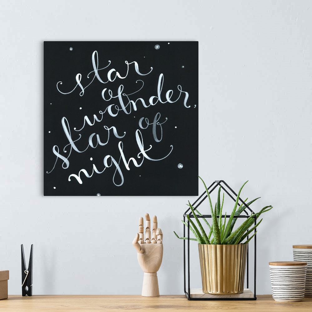 A bohemian room featuring The phrase "Star of wonder, star of night" handwritten onto a dark sky dotted with stars.