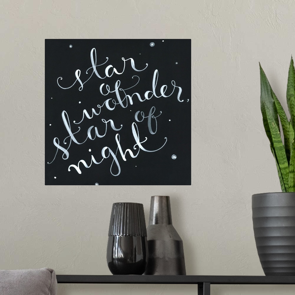 A modern room featuring The phrase "Star of wonder, star of night" handwritten onto a dark sky dotted with stars.