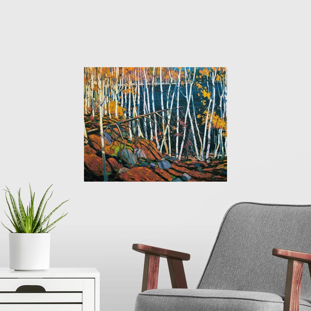 A modern room featuring A painting made on canvas of thin trees with rocks on the ground surrounding a lake.