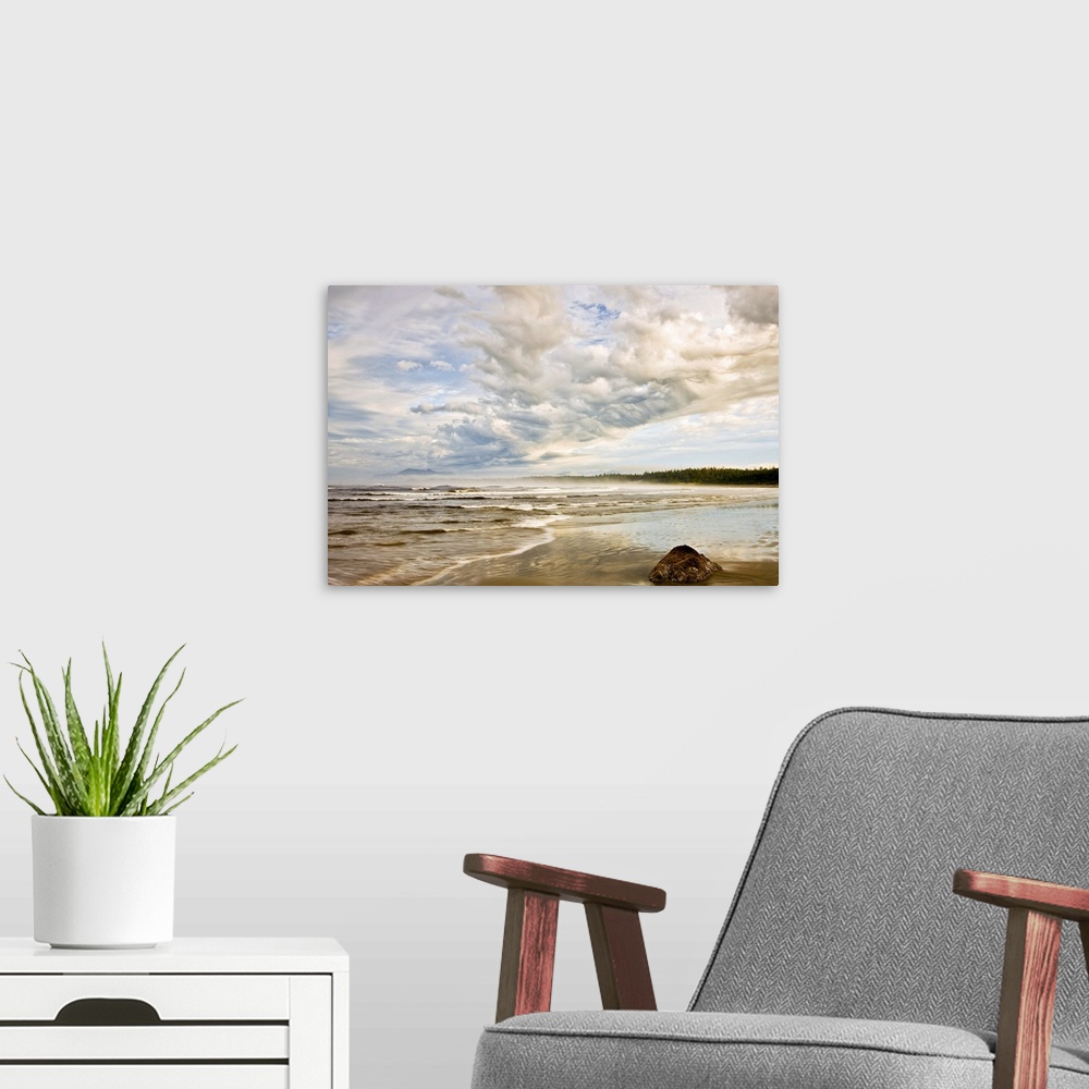 A modern room featuring Oversized, horizontal, fine art photograph of the shoreline on a beach, beneath a sky of fluffy c...