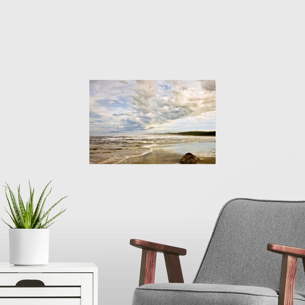 A modern room featuring Oversized, horizontal, fine art photograph of the shoreline on a beach, beneath a sky of fluffy c...