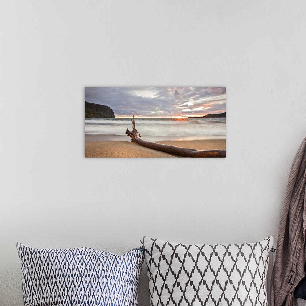 A bohemian room featuring This landscape canvas is a sandy beach at sunset sheltered with steep rock faces; the composition...