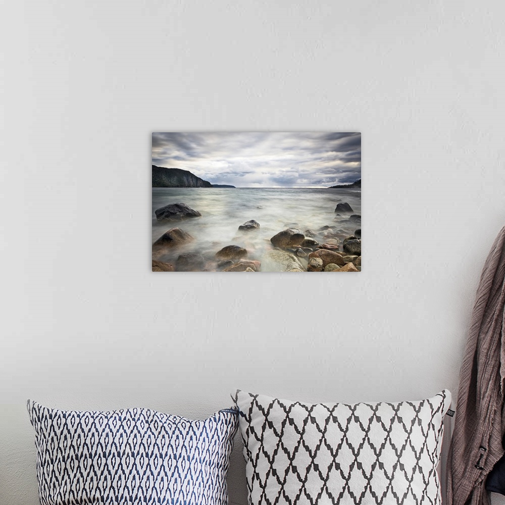 A bohemian room featuring Fine art photograph of a rocky lakeshore under a cloudy sky in Ontario.