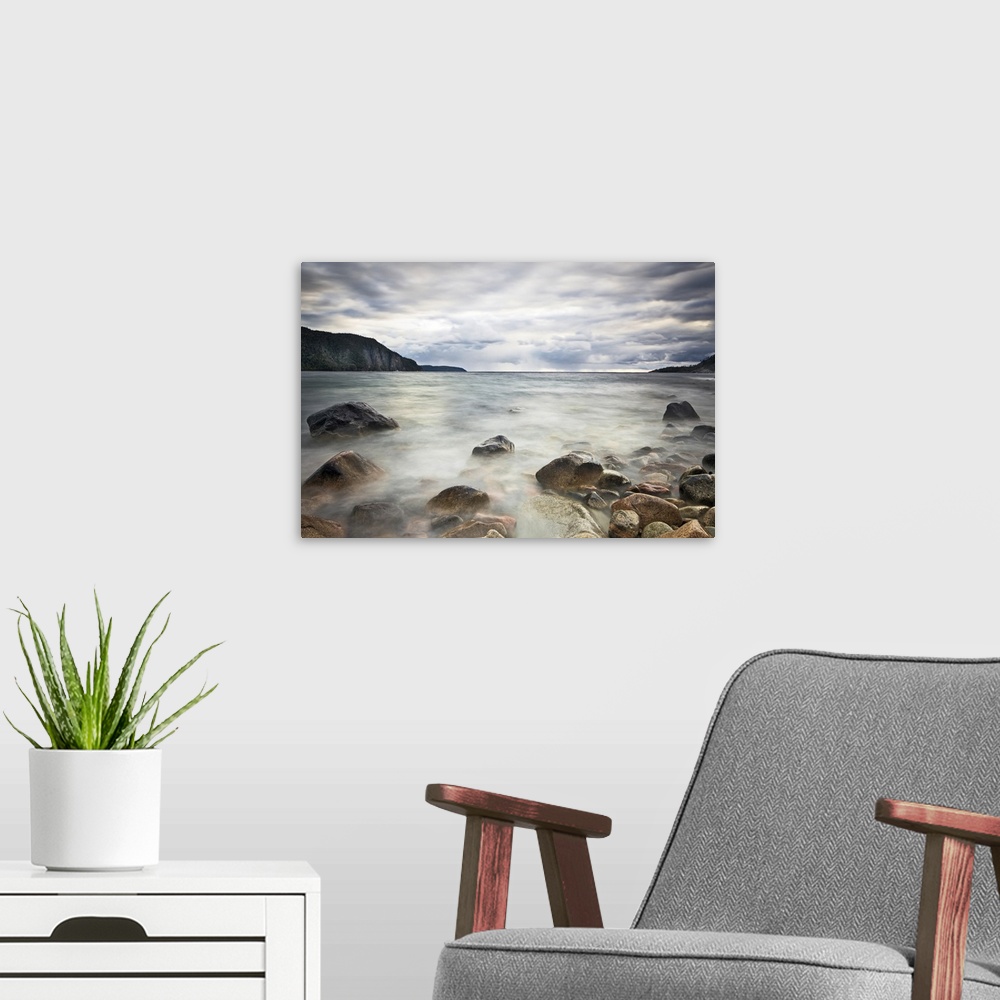 A modern room featuring Fine art photograph of a rocky lakeshore under a cloudy sky in Ontario.