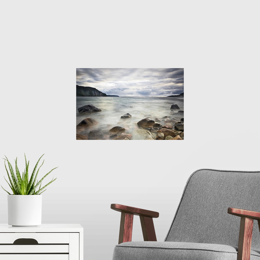 A modern room featuring Fine art photograph of a rocky lakeshore under a cloudy sky in Ontario.