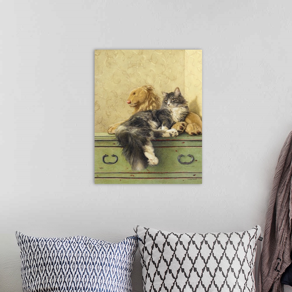 A bohemian room featuring A vertical image of a gray and white cat laying on a dresser with a stuffed lion.