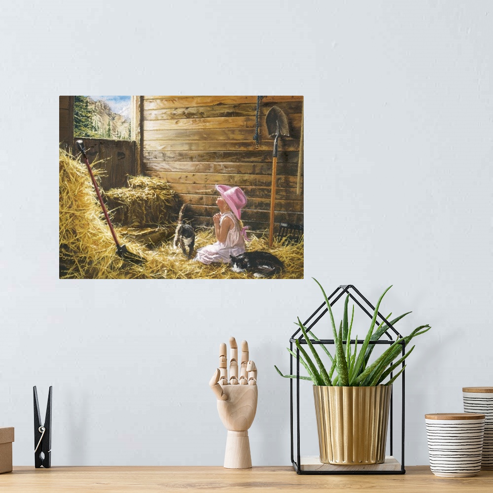 A bohemian room featuring Artwork of a little girl kneeled down inside a barn on hay with her head raised and hands clasped...