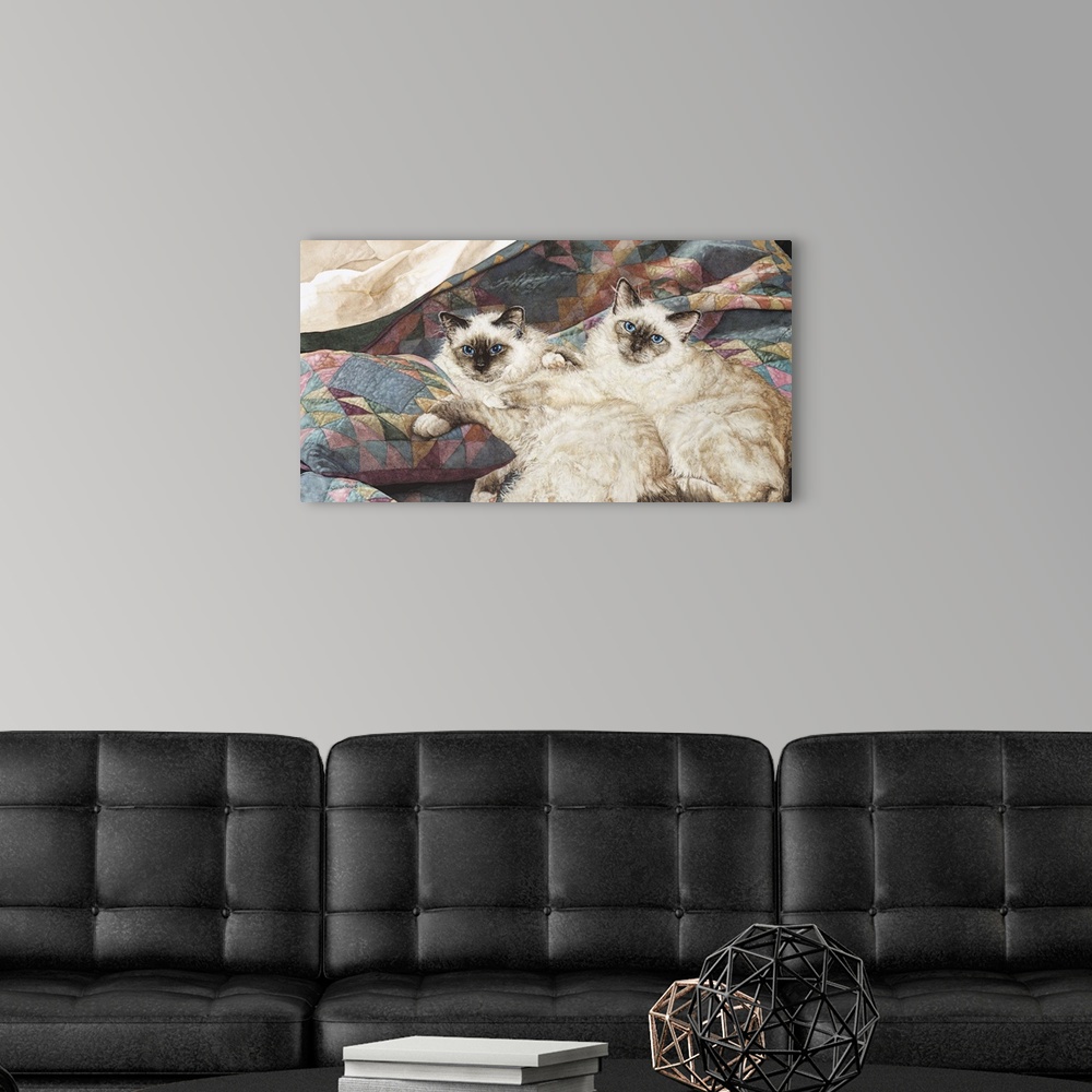 A modern room featuring A horizontal image of two cats laying on a pastel quilt.