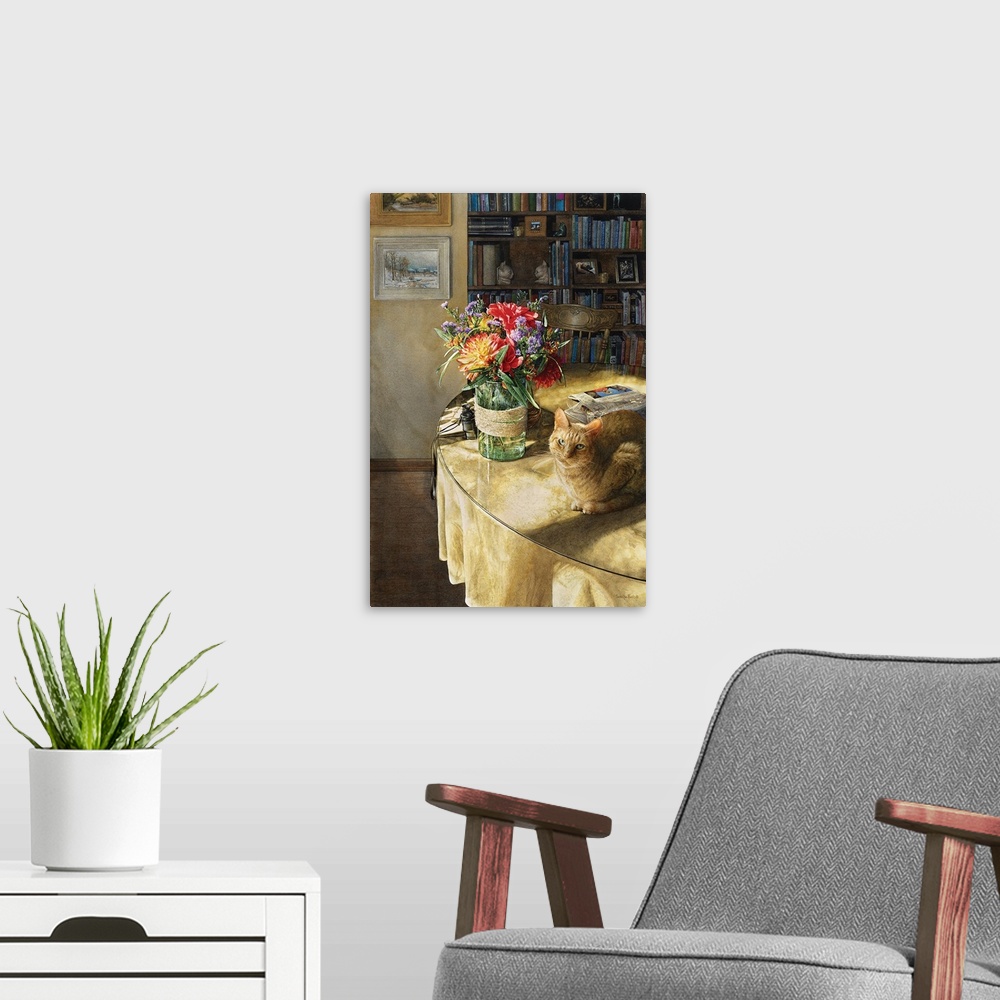 A modern room featuring Vertical image of a orange tabby sitting on a table with a glass vase of flowers and a newspaper.