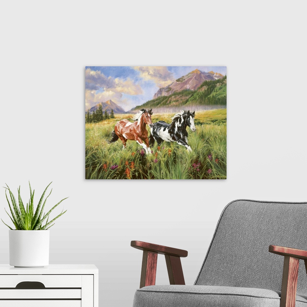 A modern room featuring Landscape artwork on a large canvas of two spotted horses running through a grassy field, large m...