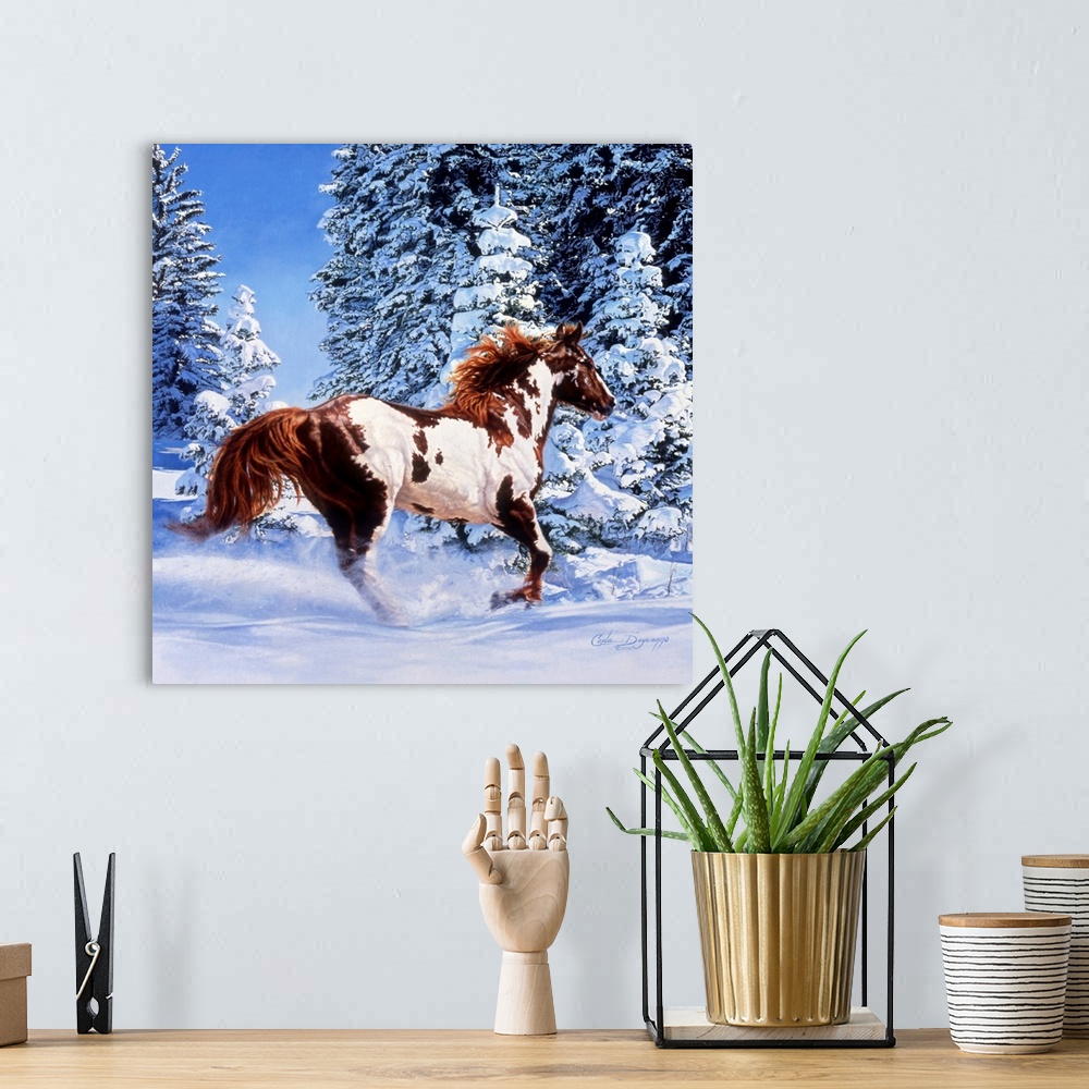 A bohemian room featuring Square, large wall picture of a brown and white horse kicking up snow as he runs through a winter...