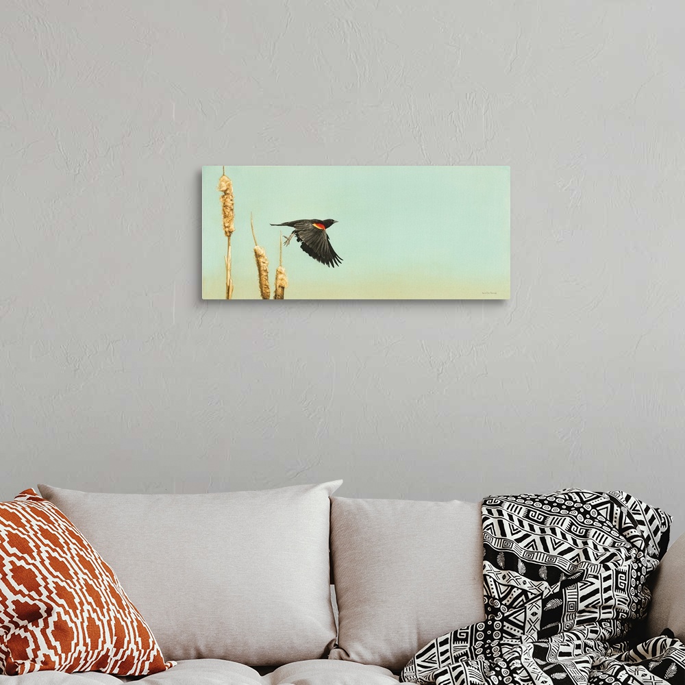 A bohemian room featuring A horizontal image of a bird starting to take flight for a cattail.