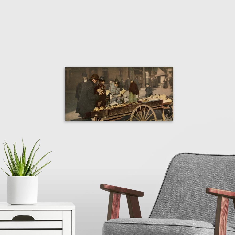 A modern room featuring Hand colored photograph of a banana cart.