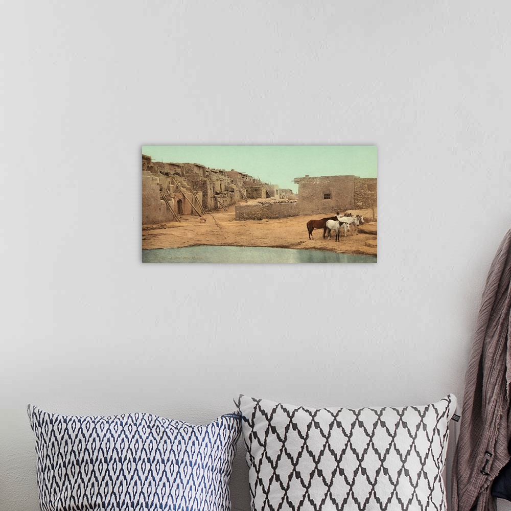 A bohemian room featuring Hand colored photograph of Acoma, New Mexico.